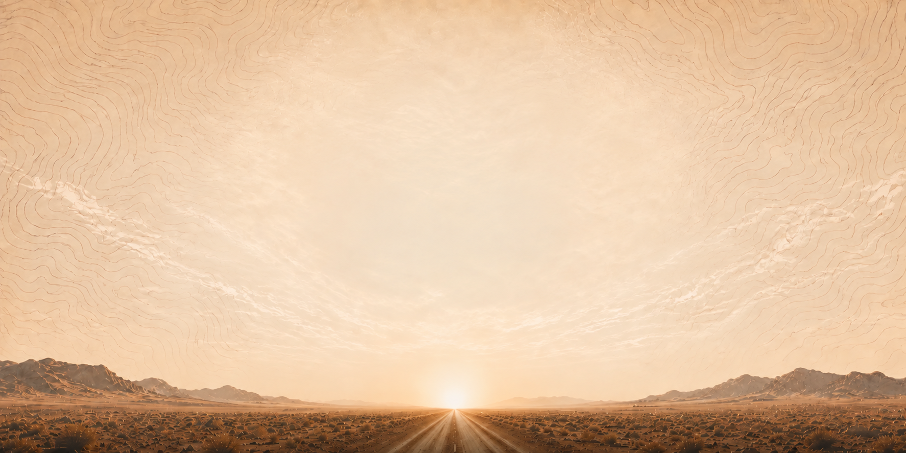 Warm desert sunrise with a road leading toward the horizon